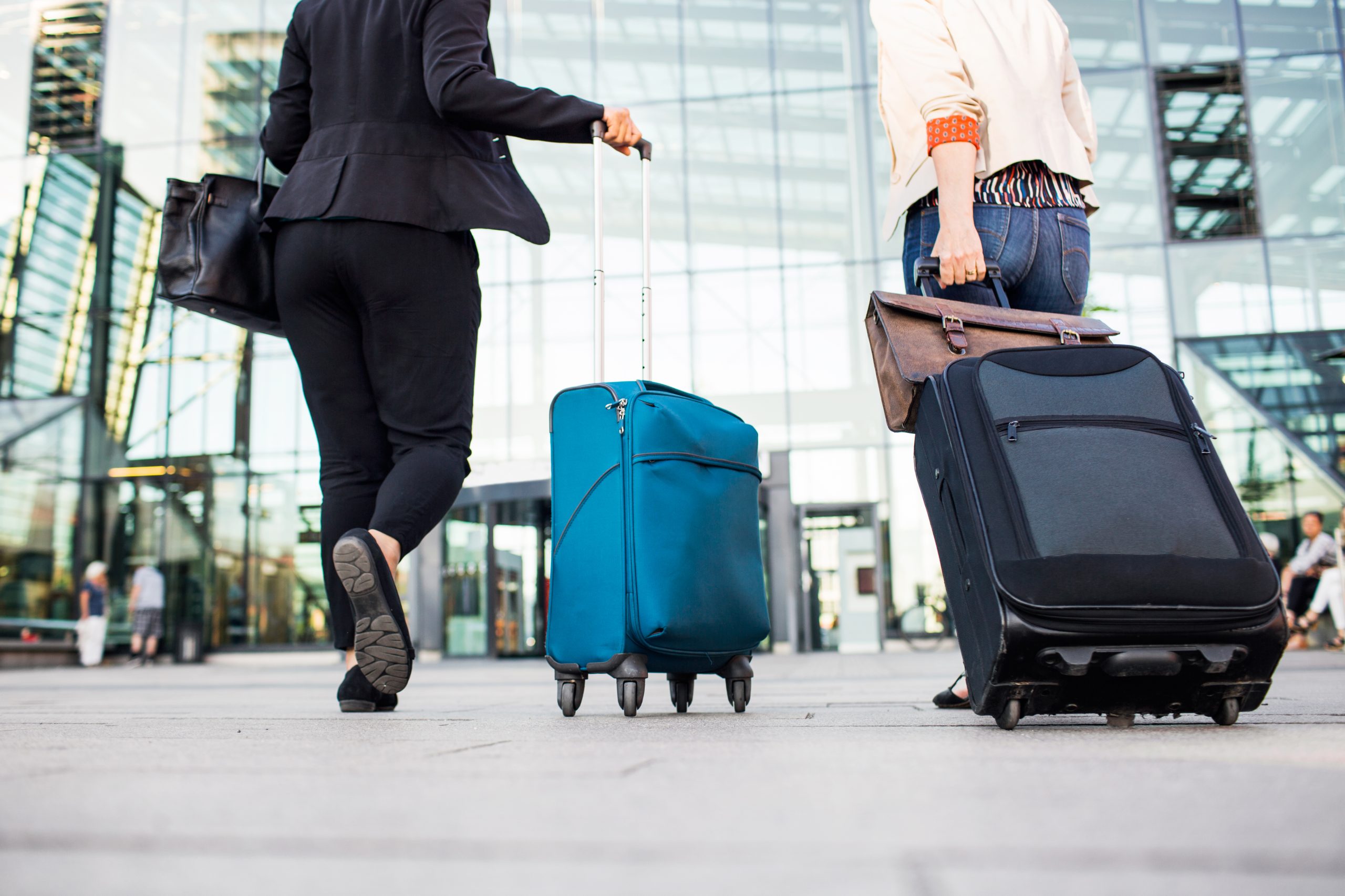 women pulling suitcases at the airport