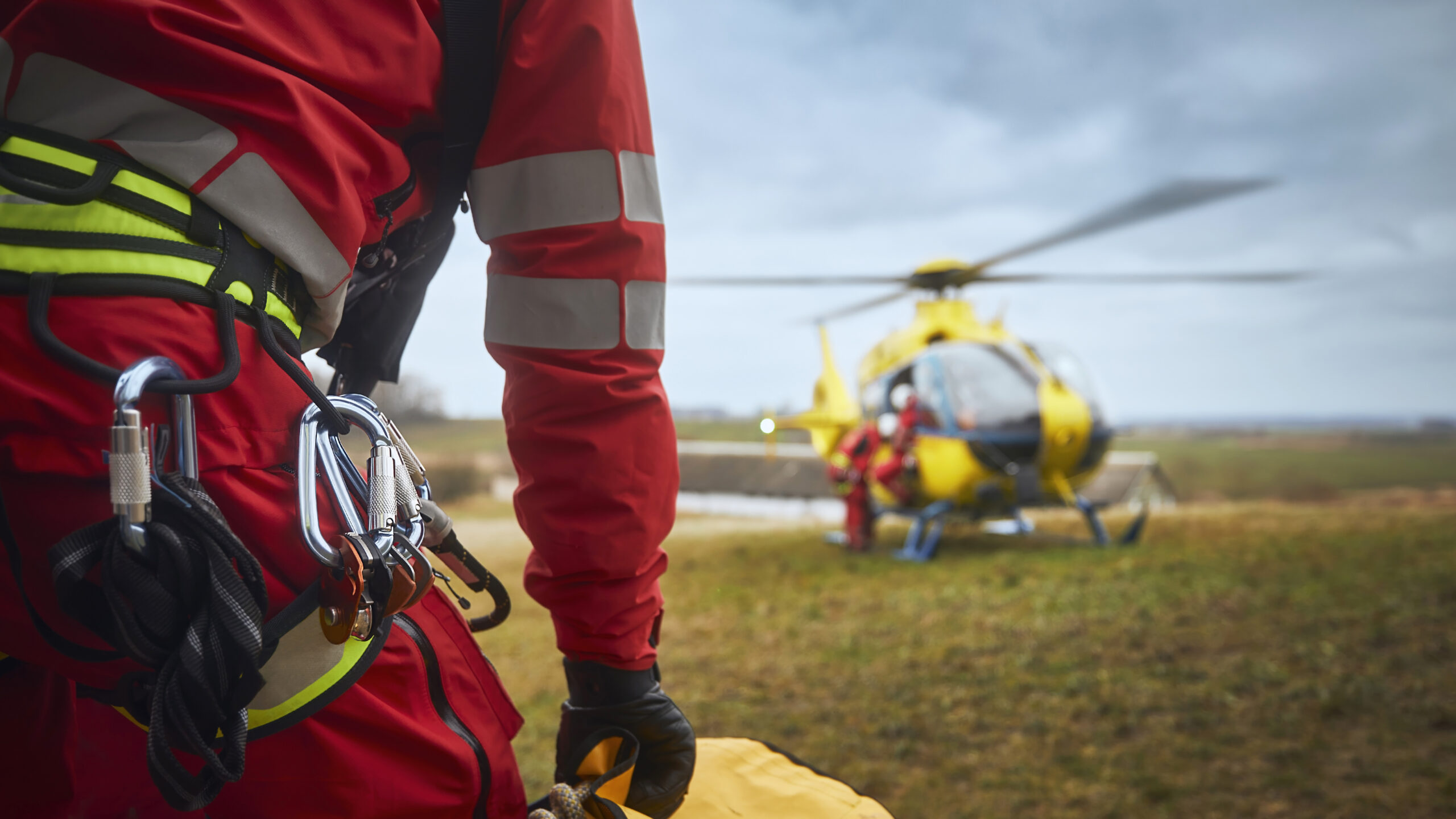 Safety harness of paramedic of emergency service in front of helicopter